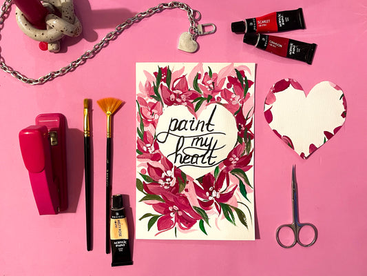 Beautiful heart-shaped Valentine's Card with floral ornament. Benicci acrylic paints, paint brushes and crafting materials are laying around.