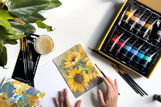 Bright acrylic artwork of sunflowers in yellow and green lying on the table. There are Acrylic Paints tubes and Paint Brushes from Benicci nearby.